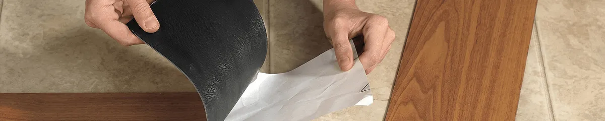 A professional installing vinyl flooring in Des Moines, IA